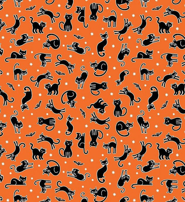 small black cats and bats on orange fabric with glow in dark outlines and stars