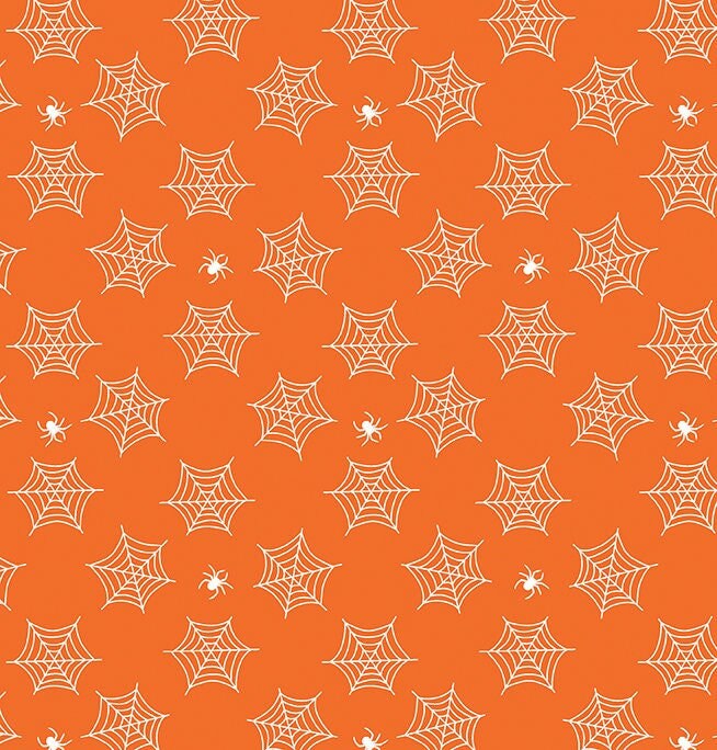 small glow in the dark spiderwebs and spiders on orange fabric